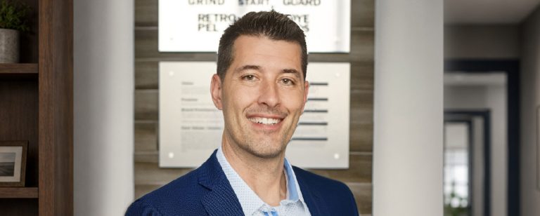 Headshot of Marco Poggio standing in Curecrete's lobby.